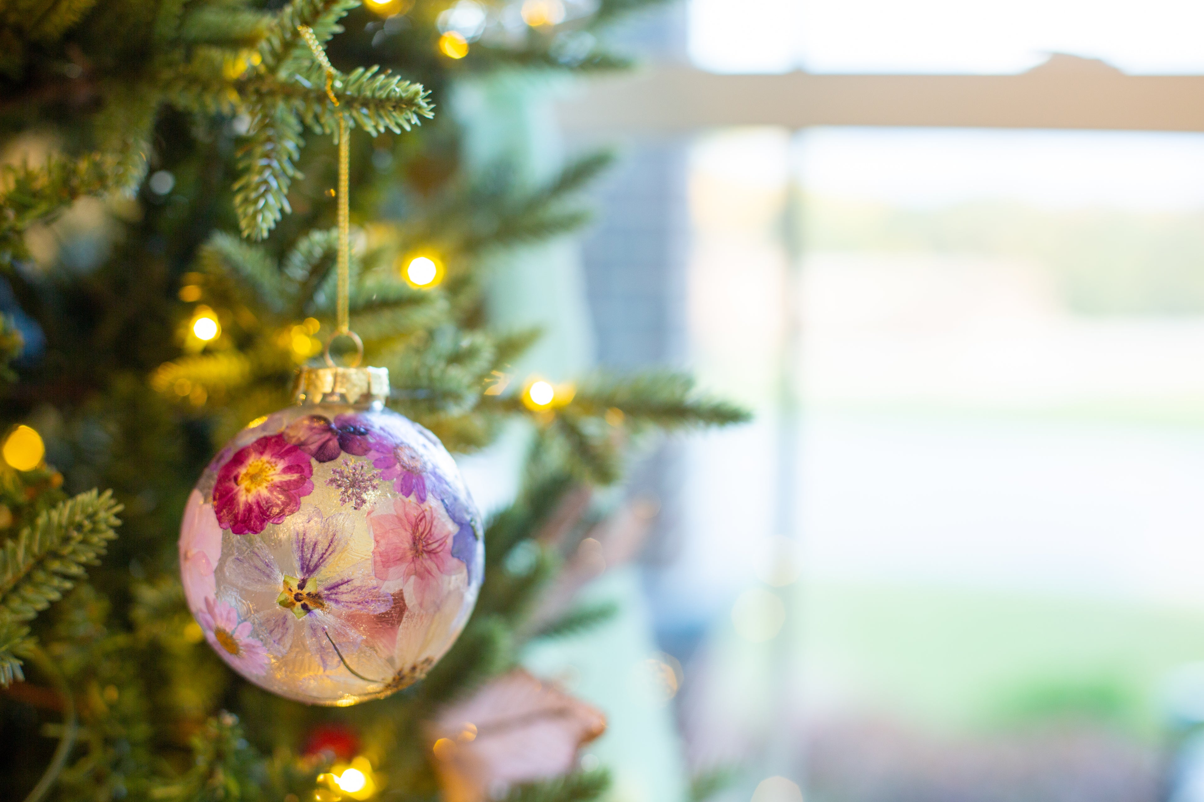 Decorative floral ornament on a Christmas tree with blurred background
